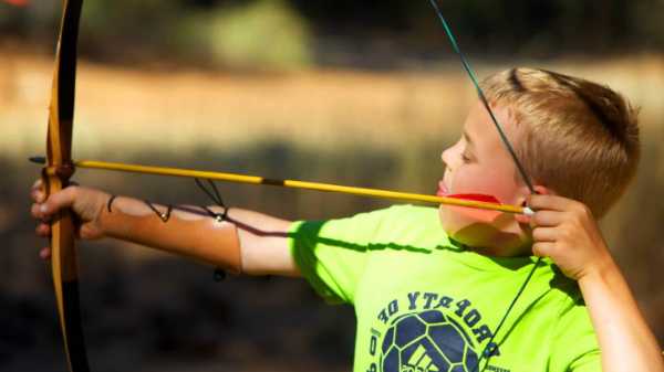 Picture showing a child doing archery as a hobby
