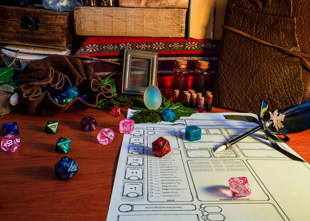 A table showing dungeons and dragons character sheet and polyhedral dice